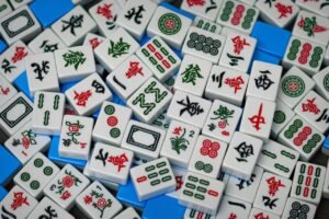 A detailed close-up view of traditional Mahjong tiles with colorful Chinese characters and symbols for gameplay.